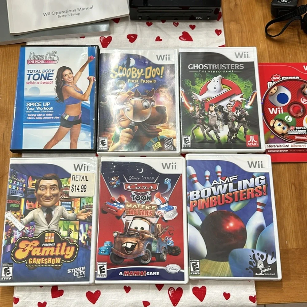 Nintendo Wii black w 2 remotes and 7 games.6 games in cases 1 has no case.